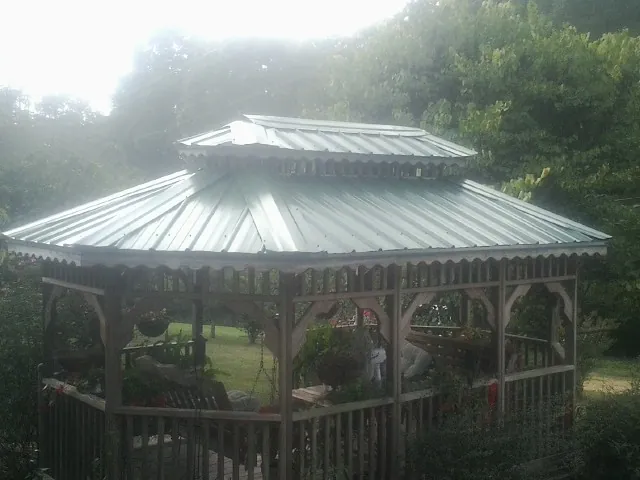 Two tier green metal roof on a garden gazebo in Cameron